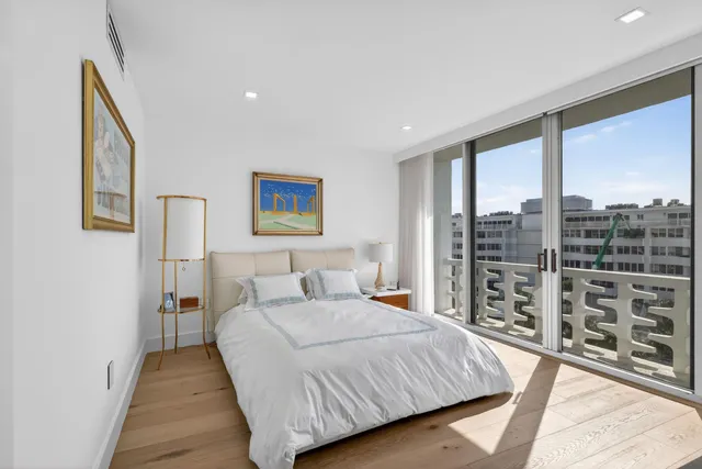 a bedroom with a large bed and a wooden floor