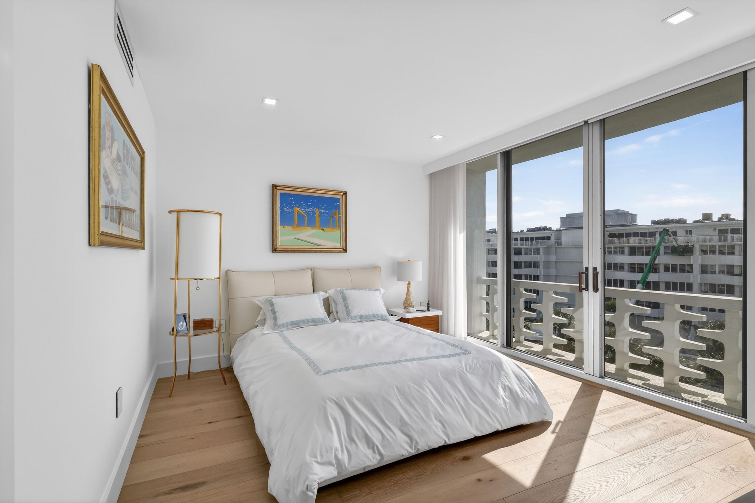 2760 South Ocean Boulevard, Unit 508 Palm Beach, FL 33480 - Photo 18 of 26 a bedroom with a large bed and a wooden floor