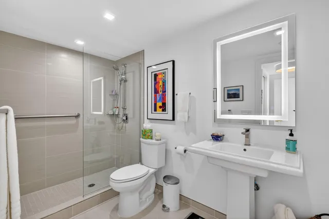 a bathroom with a sink toilet and shower