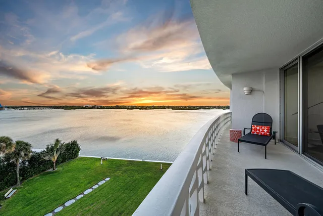 a view of swimming pool from balcony with seating space