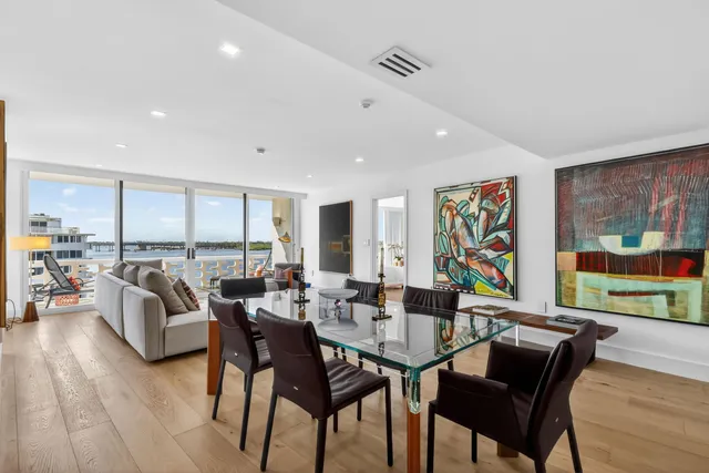 a living room with furniture and painting on the wall next to a window
