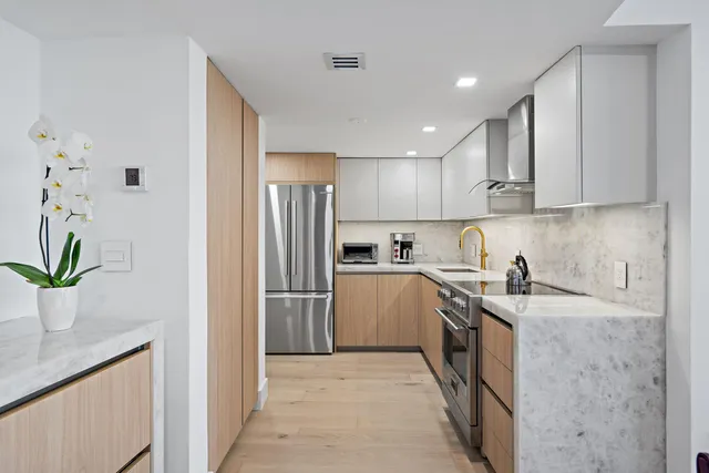 a kitchen with a sink a refrigerator and a stove