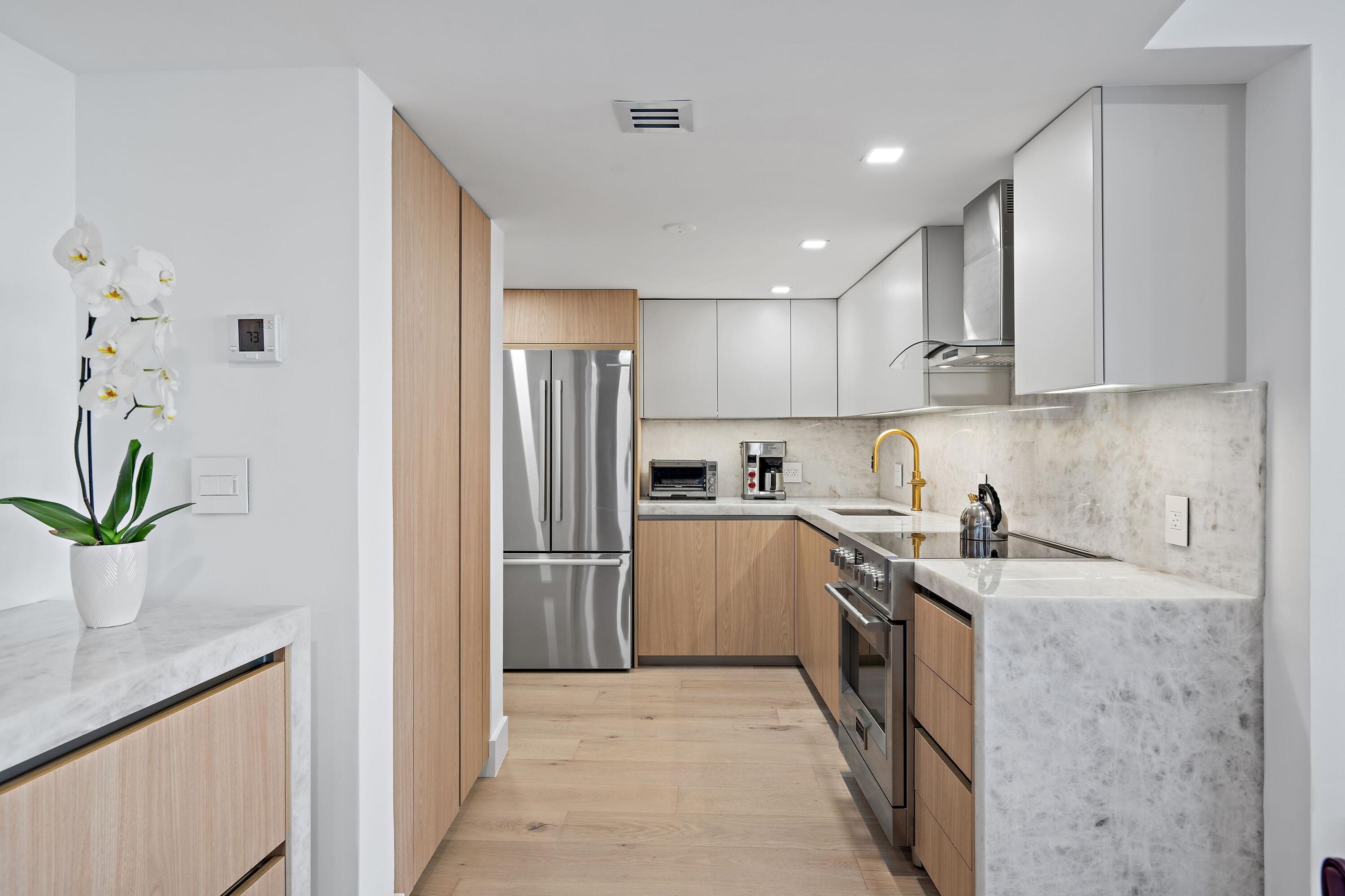 2760 South Ocean Boulevard, Unit 508 Palm Beach, FL 33480 - Photo 7 of 26 a kitchen with a sink a refrigerator and a stove