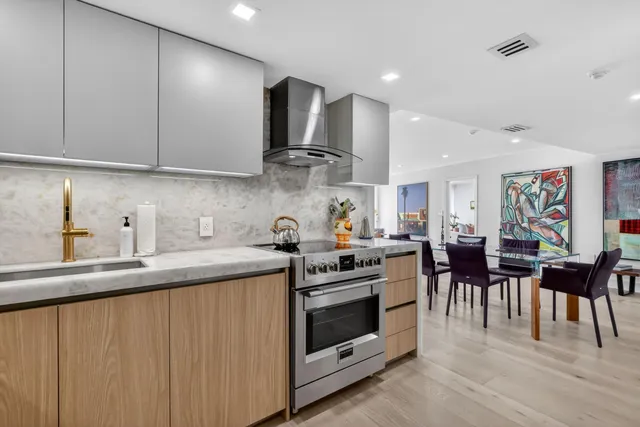 a kitchen with stainless steel appliances a stove top oven