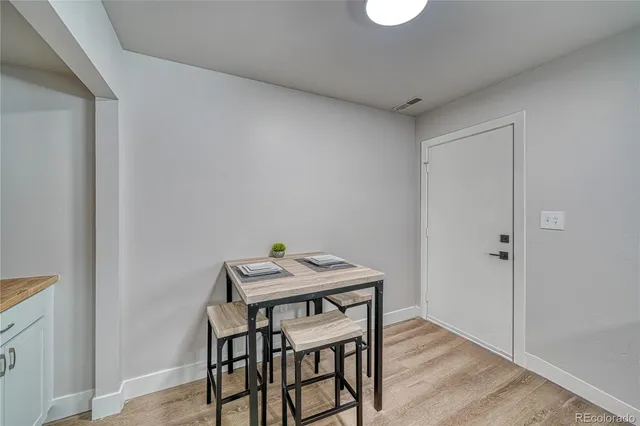 a view of a dining room with furniture and wooden floor