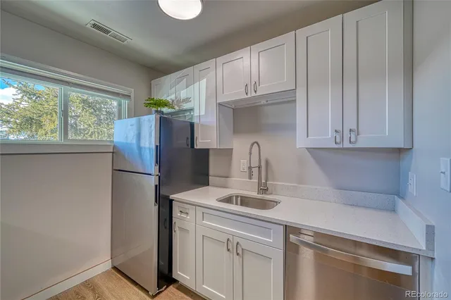 a kitchen with stainless steel appliances granite countertop a refrigerator sink and cabinets