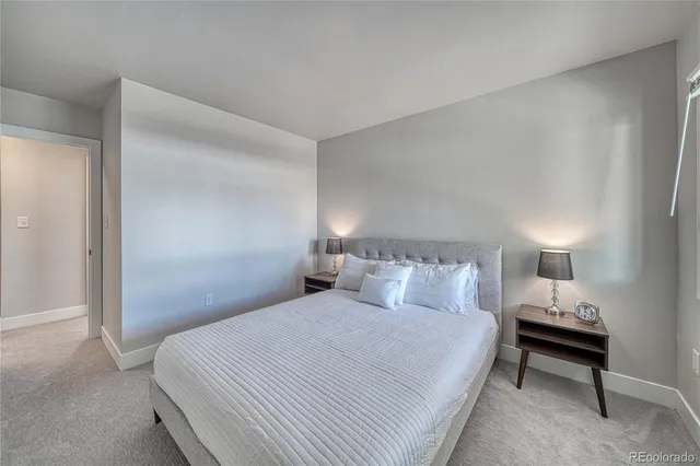 a bedroom with a bed and a lamp