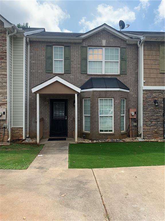 1519 Conley Way Conley, GA 30288 - Photo 1 of 1 a front view of a house with a garden and yard