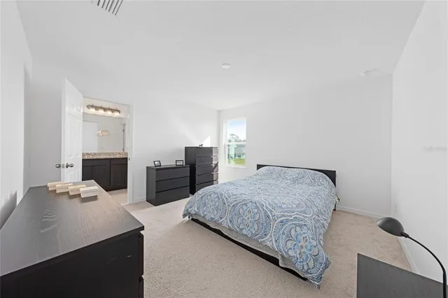 a bedroom with a bed and two tables