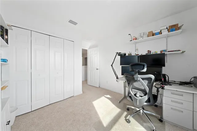 a view of a workspace with furniture and a window