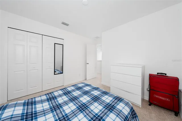 a bedroom with a bed and a cabinets