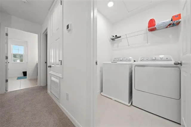 a bathroom with a refrigerator and a sink