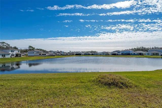 a view of a lake with houses in the back