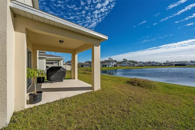 a view of a patio with a table and chairs under an umbrella