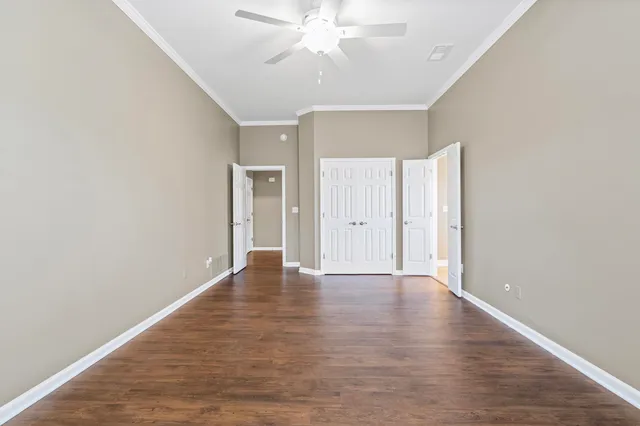 a view of an empty room with wooden floor