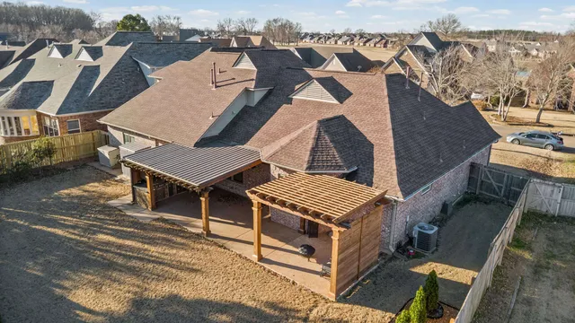 an aerial view of a house with a yard