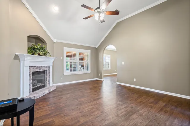 a view of an empty room with a fireplace and a window
