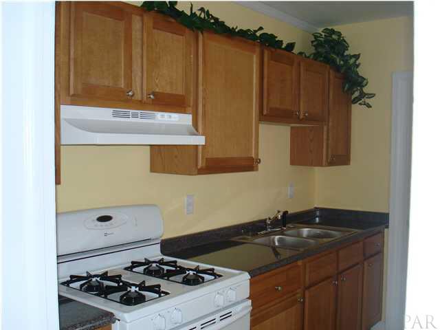 101 Ruberia Avenue Pensacola, FL 32507 - Photo 3 of 12 Oak cabinets, new gas stove & hood, new sink & faucet.