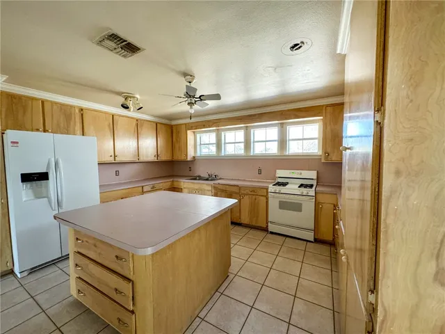 a kitchen with a stove a sink and a refrigerator