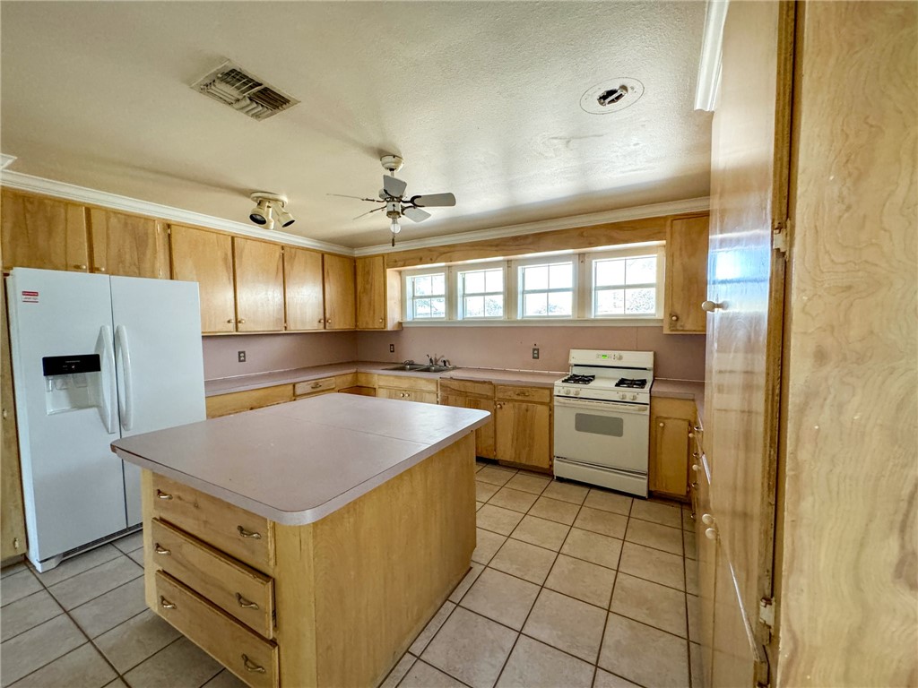 3712 Highway 59 George West, TX 78022 - Photo 3 of 14 a kitchen with a stove a sink and a refrigerator