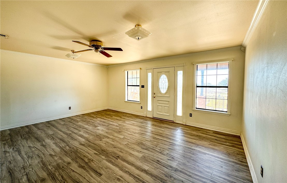 3712 Highway 59 George West, TX 78022 - Photo 5 of 14 a view of an empty room with a window and wooden floor