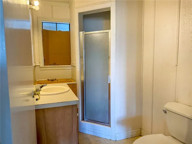 a bathroom with a sink and mirror with toilet