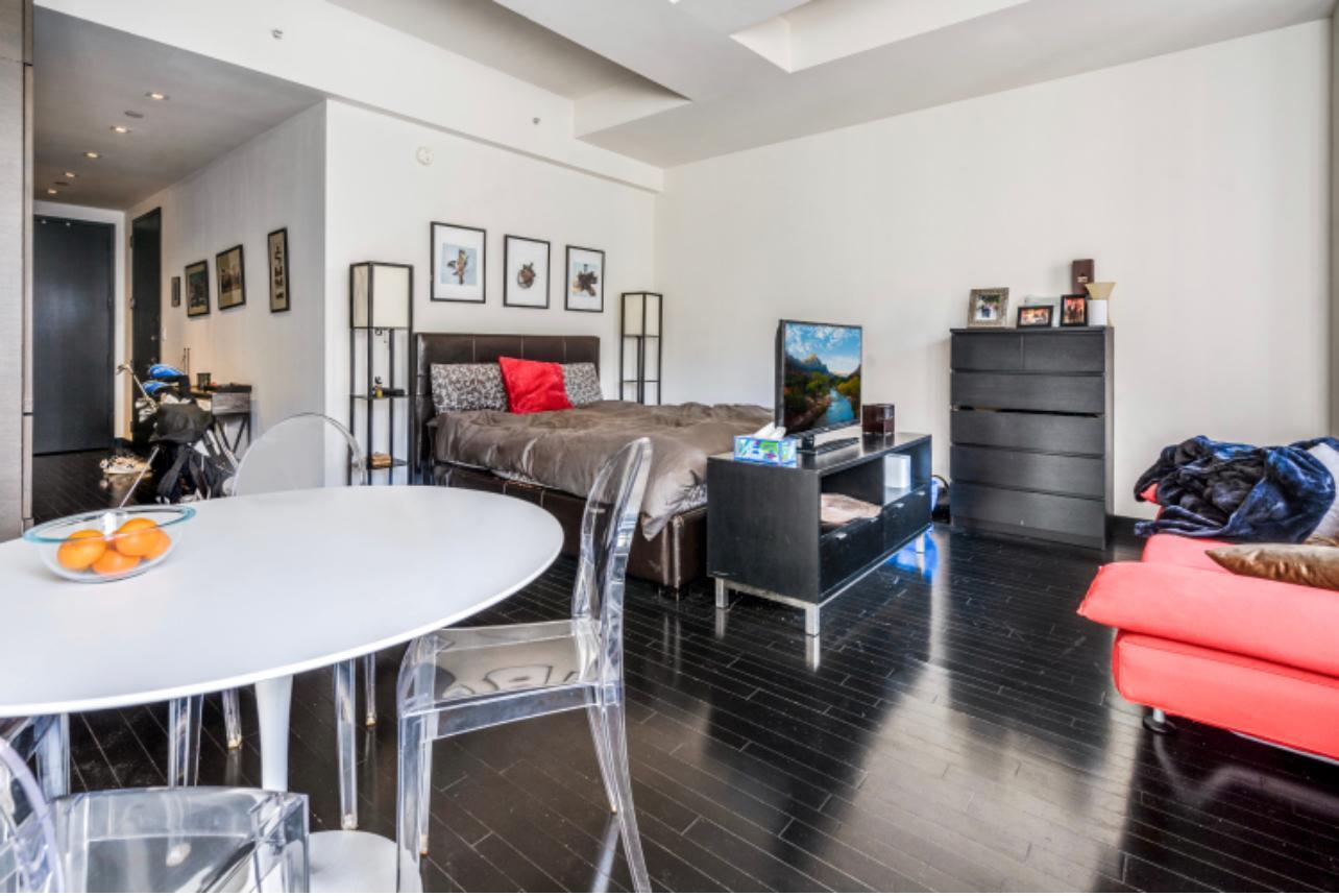 20 Pine Street, Unit 2205 Manhattan, NY 10005 - Photo 3 of 10 a view of a dining room with furniture