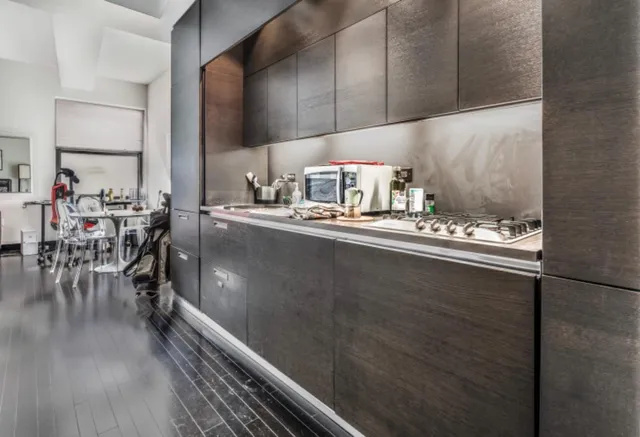 a bed sitting in a bedroom next to a window with tv