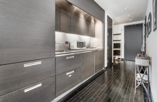 a kitchen with a sink and wooden cabinets