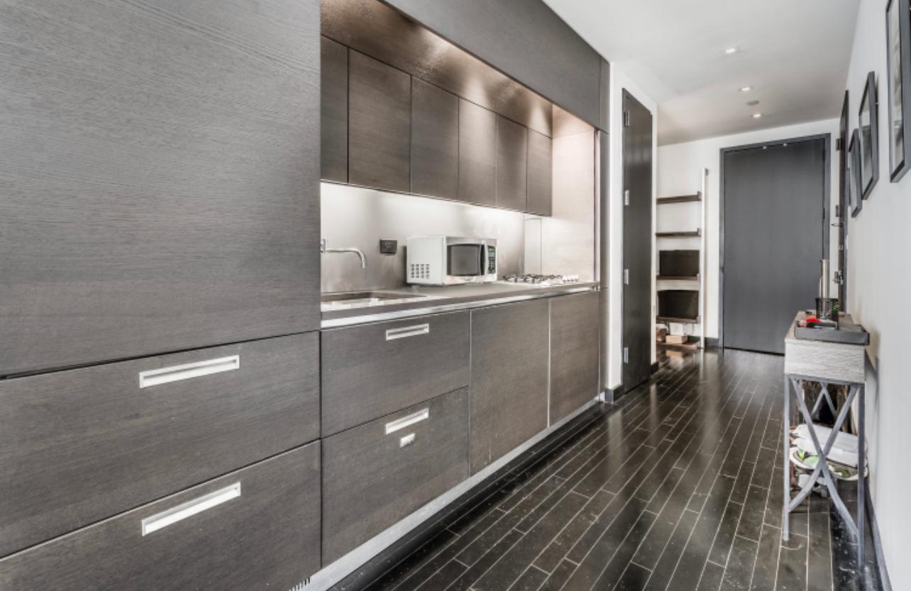 20 Pine Street, Unit 2205 Manhattan, NY 10005 - Photo 7 of 10 a kitchen with stainless steel appliances granite countertop a refrigerator and a stove