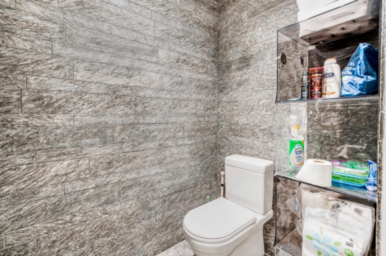 20 Pine Street, Unit 2205 Manhattan, NY 10005 - Photo 8 of 10 a white toilet sitting next to a sink