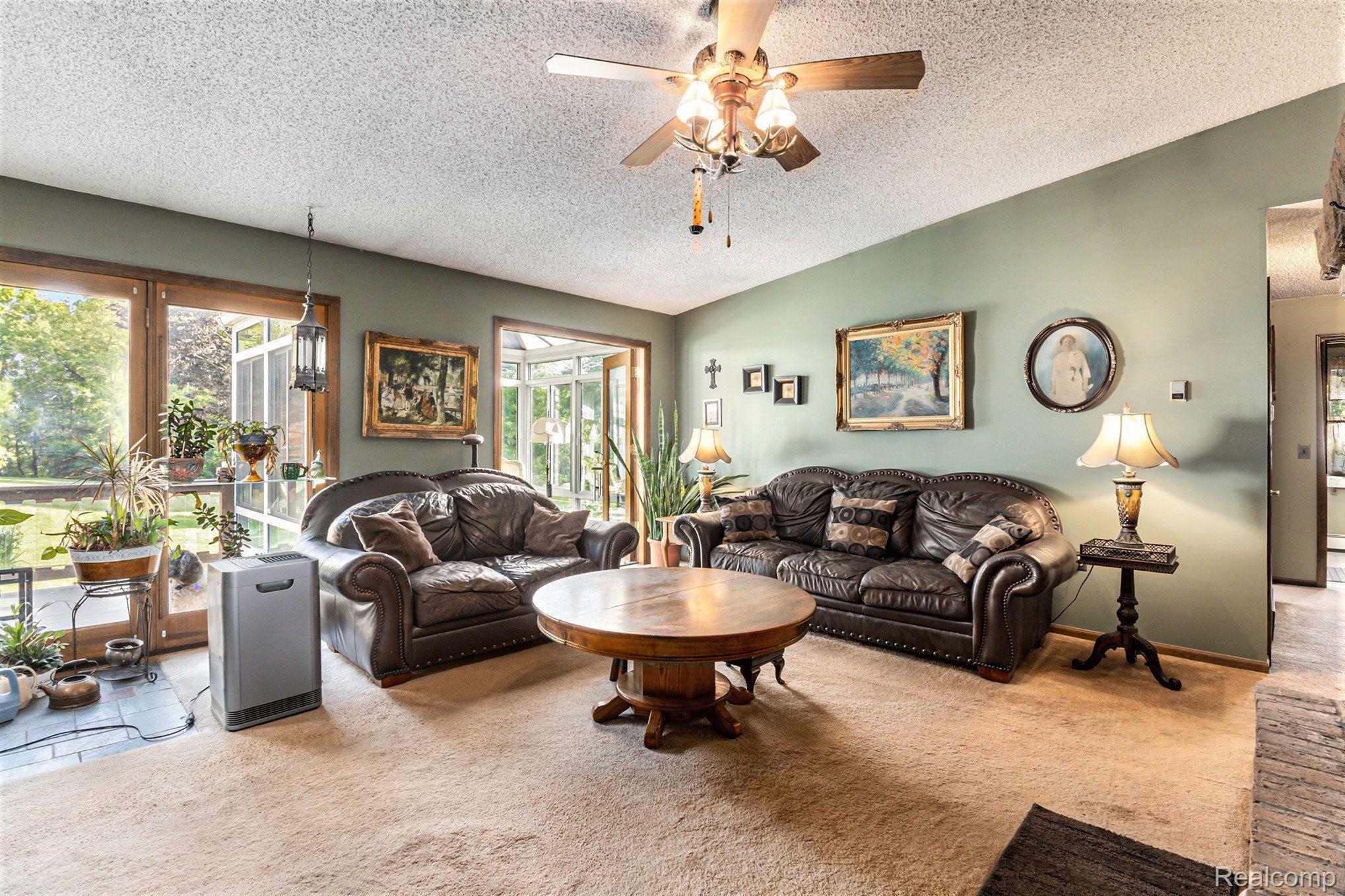 7280 Groveland Road Holly, MI 48442 - Photo 11 of 48 living room with large windows & sunroom entrance