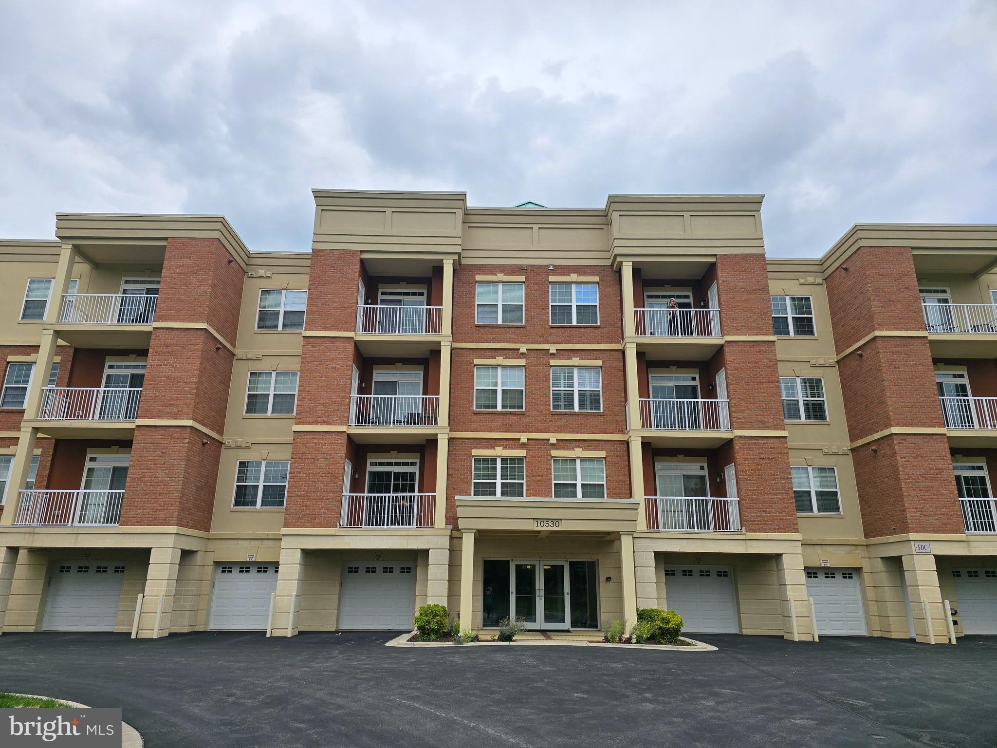 10530 Resort Road, Unit 101 Ellicott City, MD 21042 - Photo 2 of 13 a front view of a building with many windows