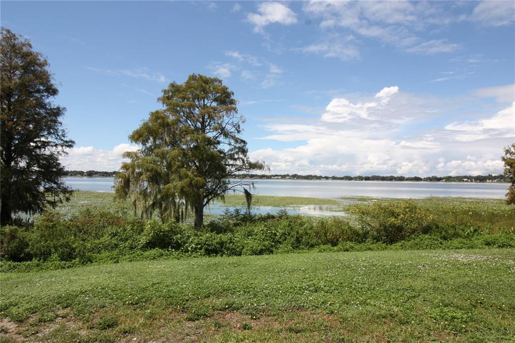 521 20th Street Southwest, Unit C Winter Haven, FL 33880 - Photo 18 of 18 a view of a lake from a yard