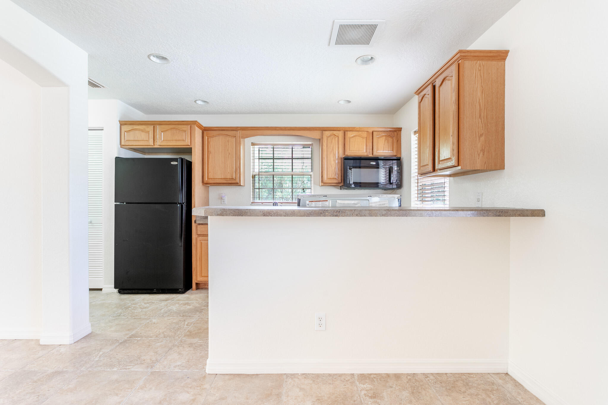 441 Lucas Road Merritt Island, FL 32953 - Photo 3 of 17 a kitchen with a refrigerator and a sink