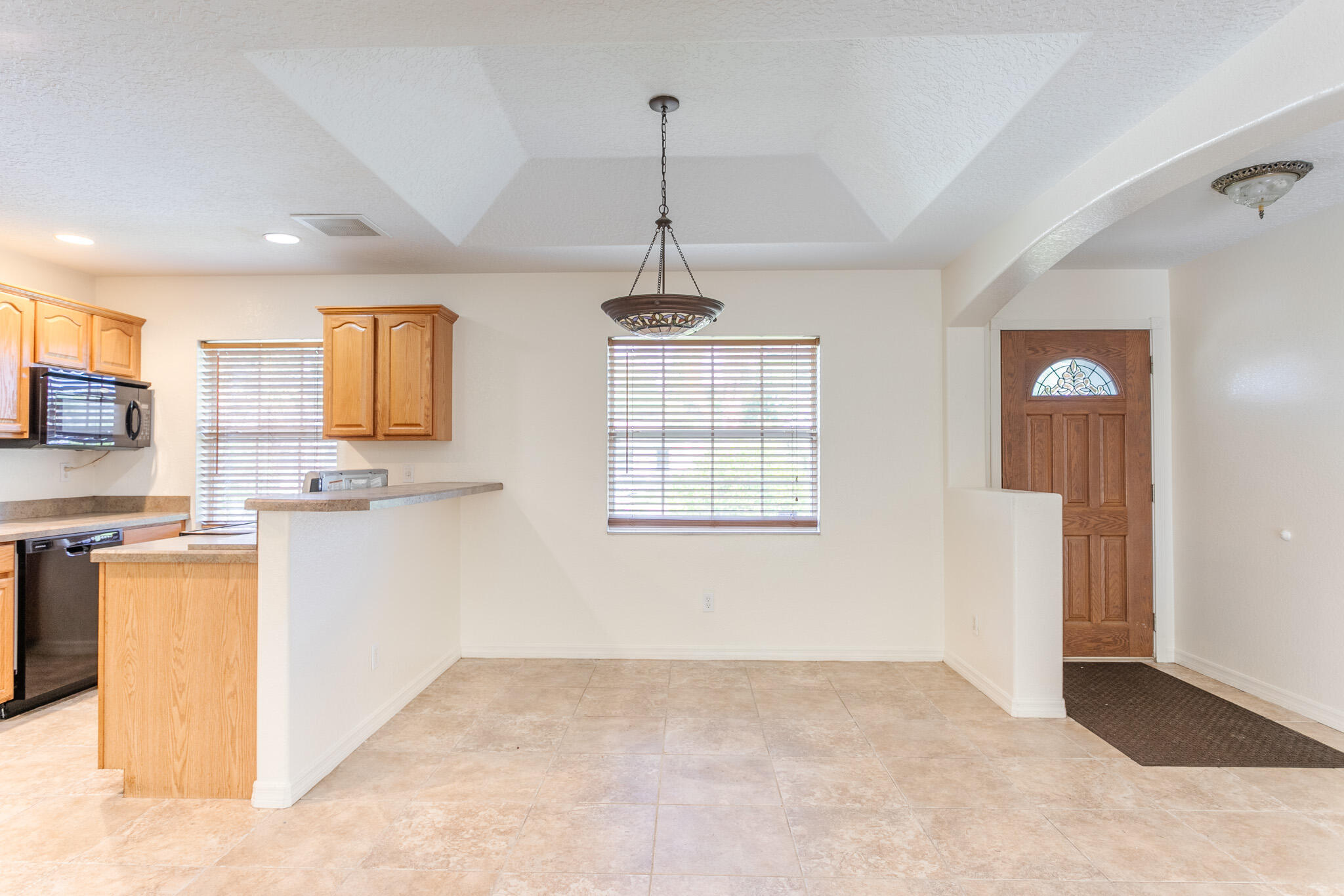 441 Lucas Road Merritt Island, FL 32953 - Photo 4 of 17 a kitchen with stainless steel appliances granite countertop a refrigerator a stove a sink dishwasher and white cabinets with wooden floor