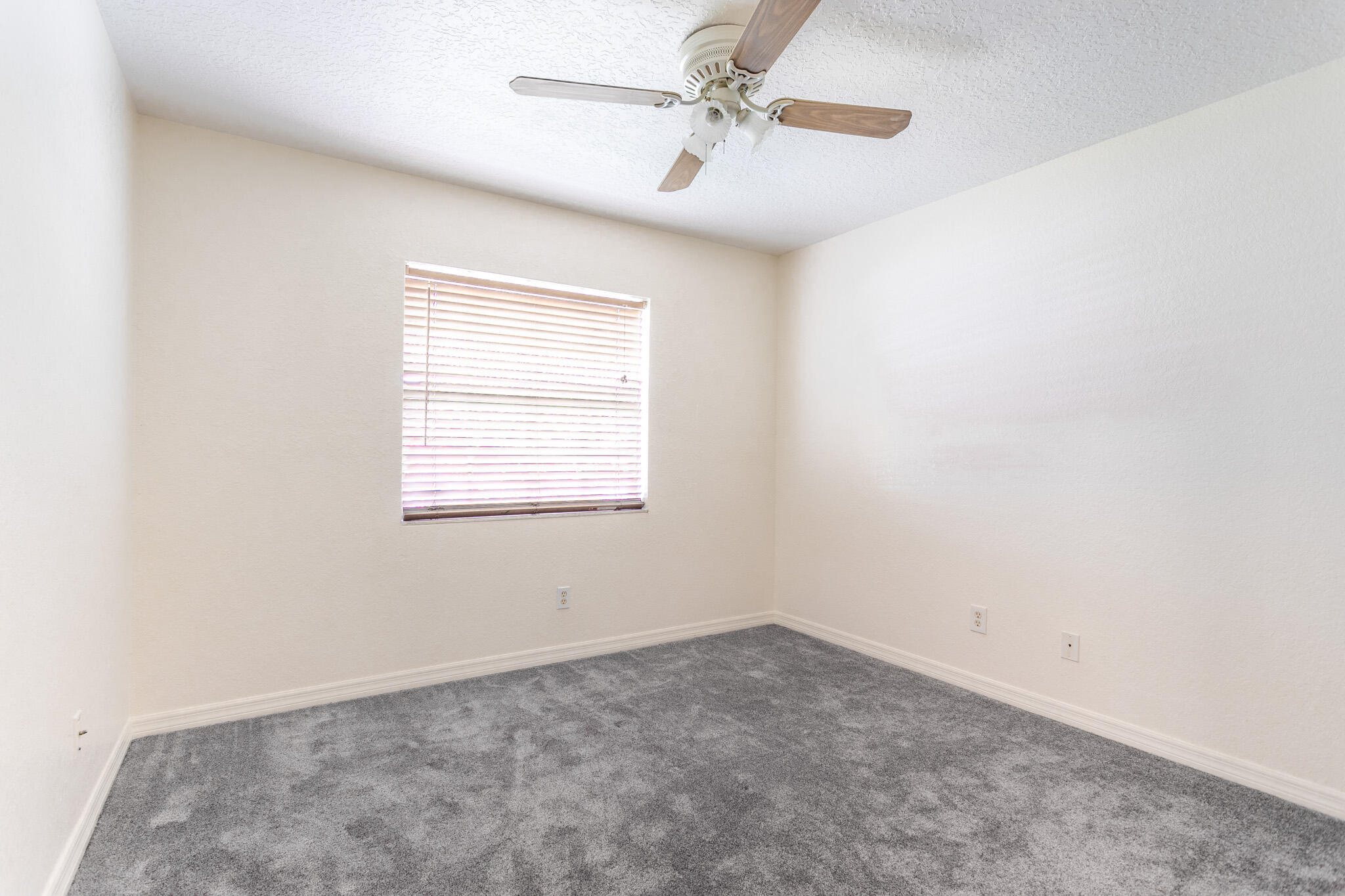 441 Lucas Road Merritt Island, FL 32953 - Photo 9 of 17 an empty room with a window and ceiling fan