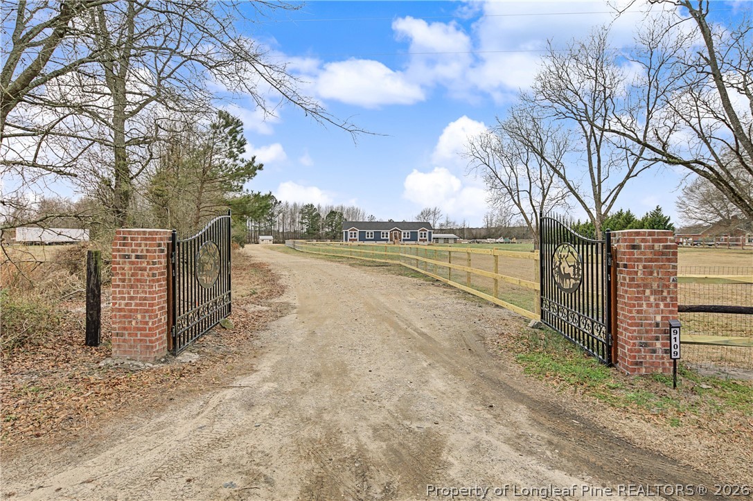 9109 Chicken Foot Road St. Pauls, NC 28384 - Photo 2 of 50 Gated entrance on fully fenced property