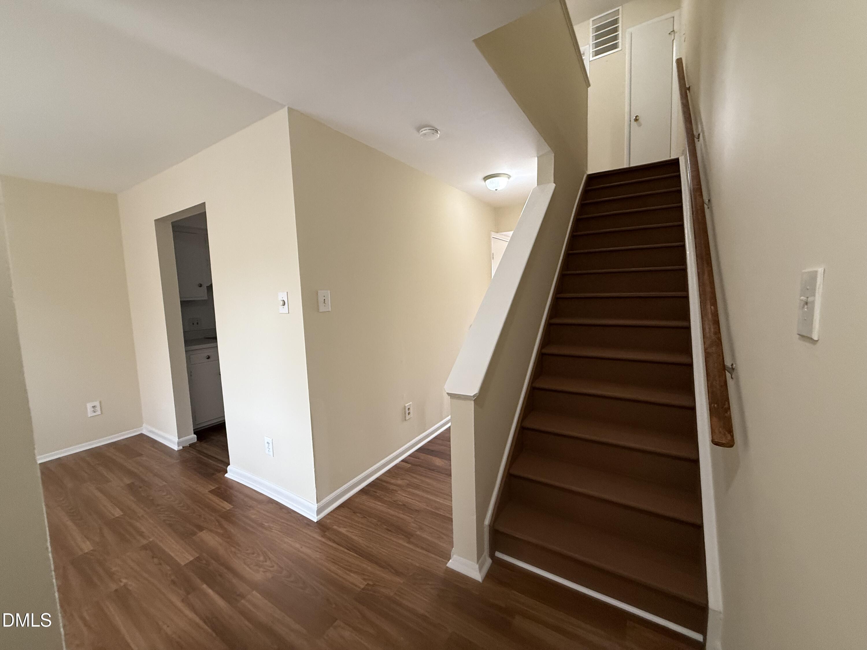 1228 Teakwood Place Raleigh, NC 27606 - Photo 11 of 30 a view of entryway and hall with wooden floor