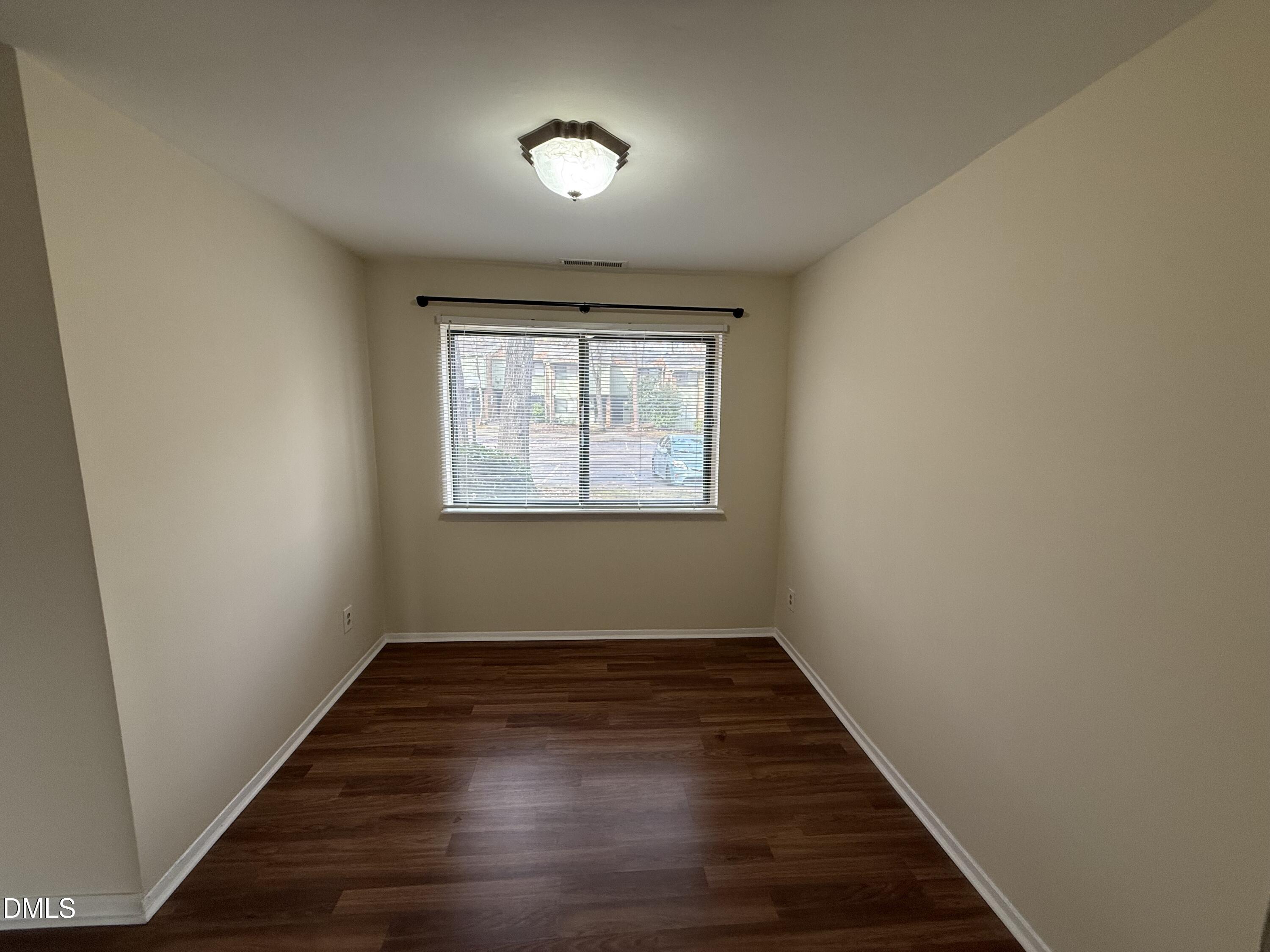 1228 Teakwood Place Raleigh, NC 27606 - Photo 13 of 30 an empty room with wooden floor and windows