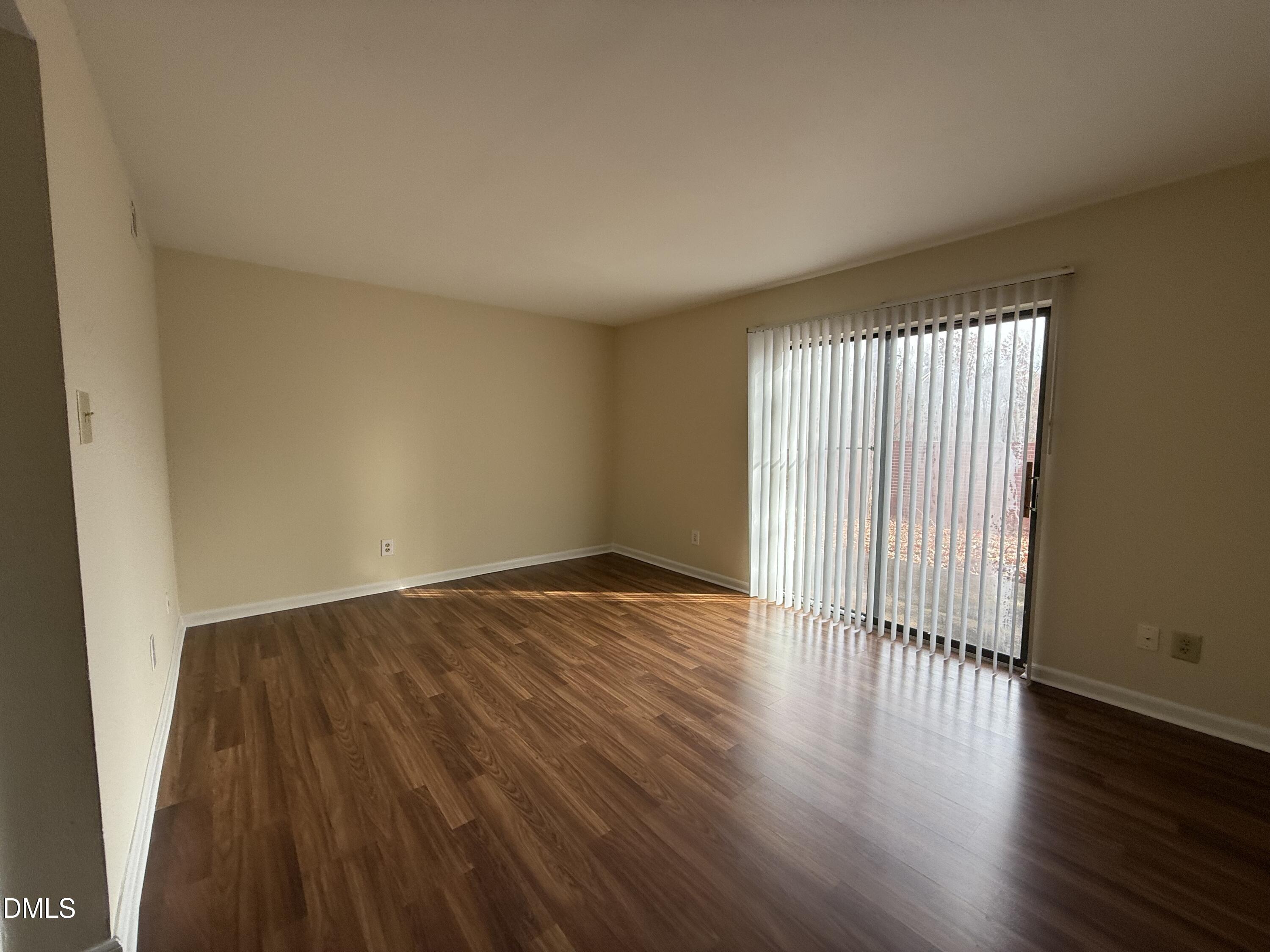 1228 Teakwood Place Raleigh, NC 27606 - Photo 14 of 30 an empty room with wooden floor and windows
