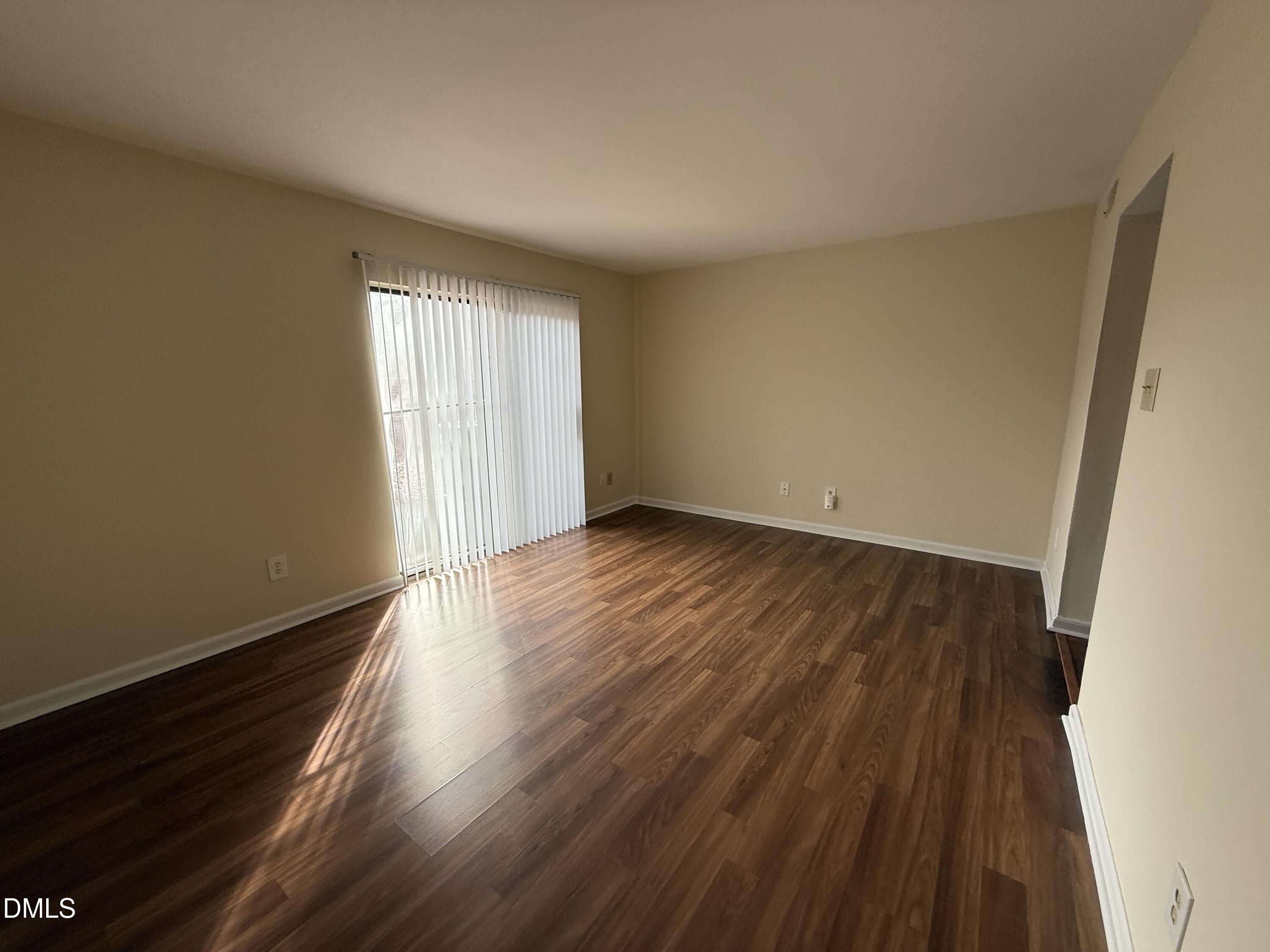 1228 Teakwood Place Raleigh, NC 27606 - Photo 15 of 30 an empty room with wooden floor and windows