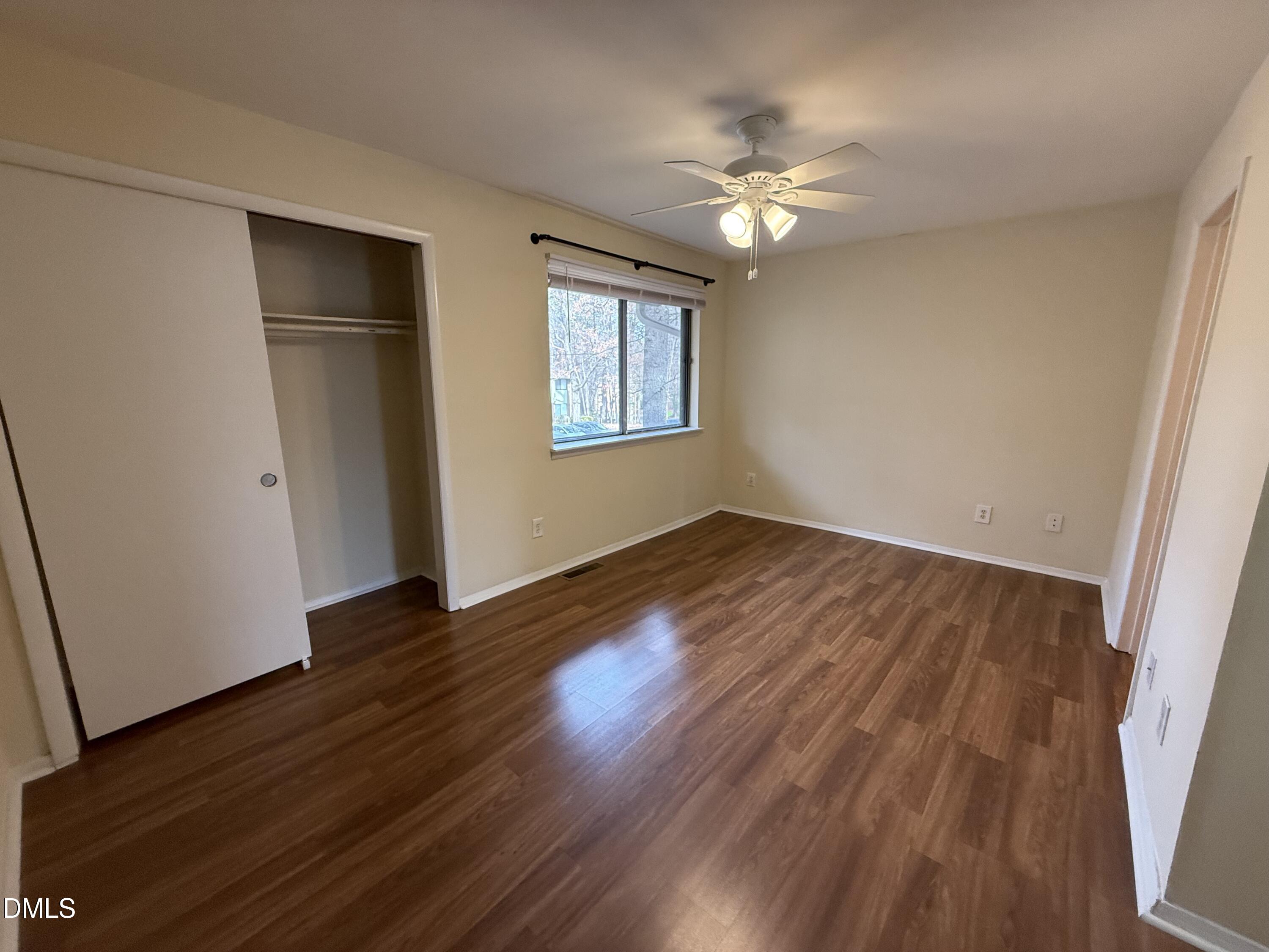 1228 Teakwood Place Raleigh, NC 27606 - Photo 20 of 30 a view of an empty room with wooden floor and a window