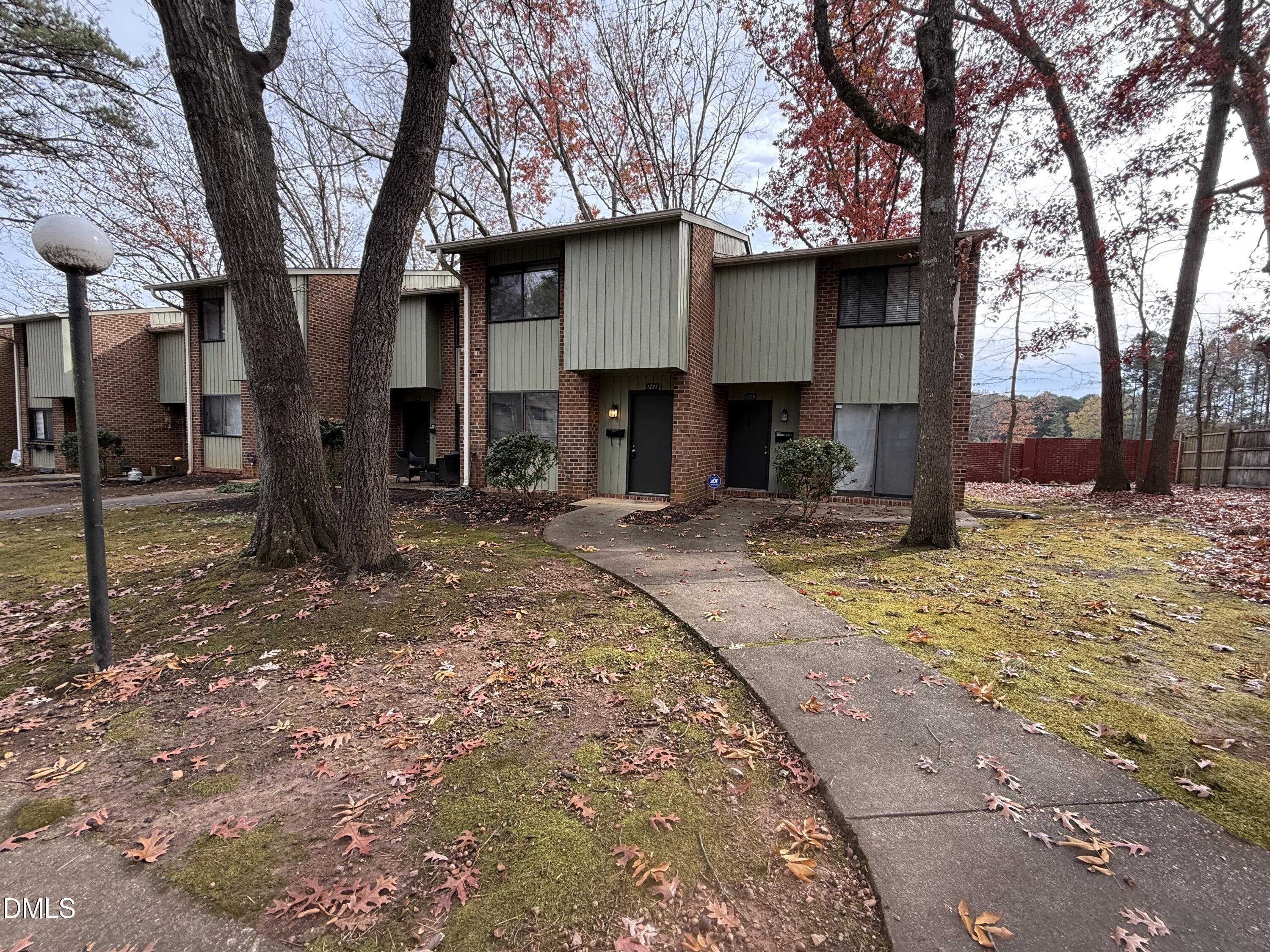 1228 Teakwood Place Raleigh, NC 27606 - Photo 4 of 30 a house with trees in front of it