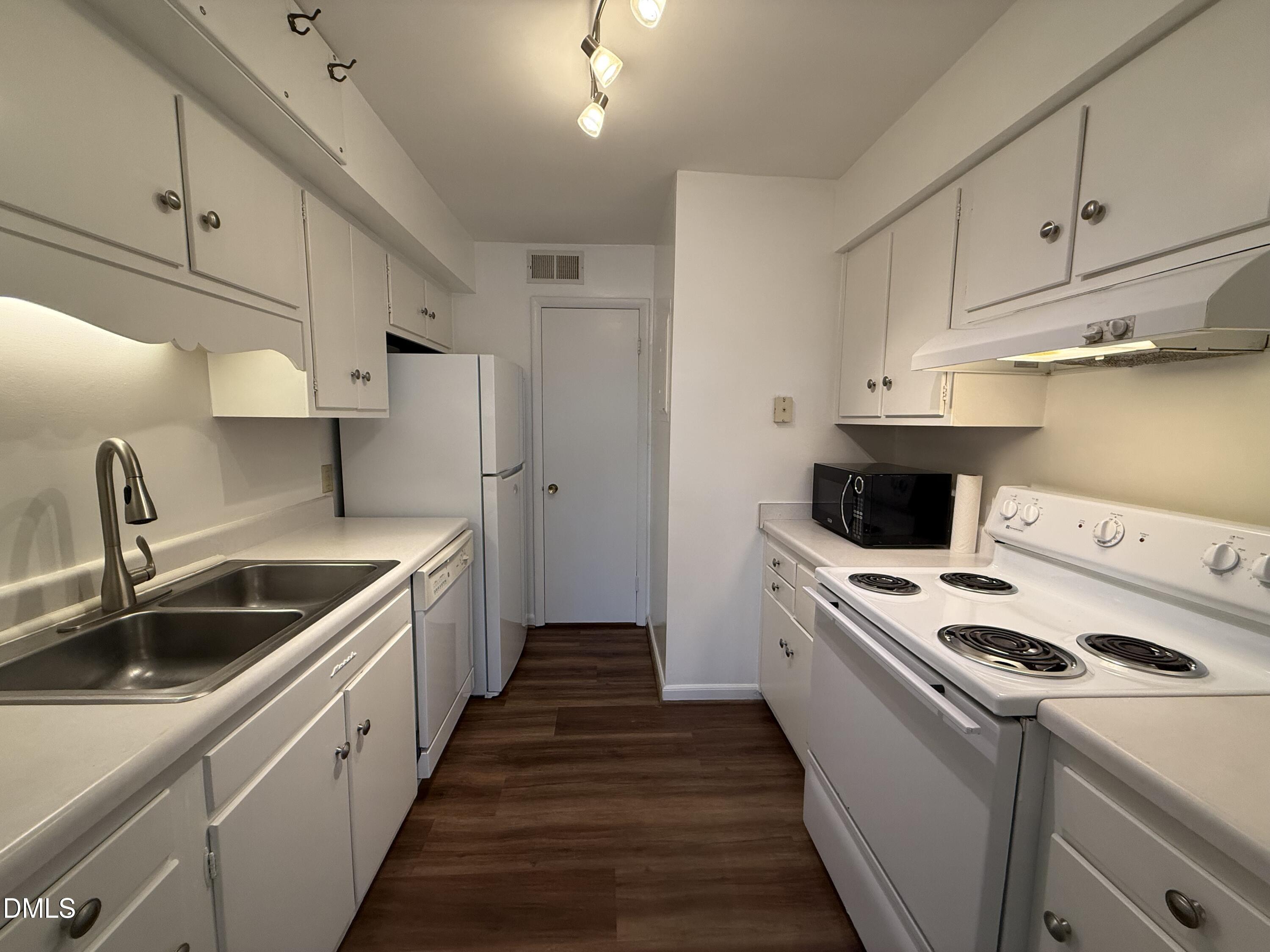 1228 Teakwood Place Raleigh, NC 27606 - Photo 6 of 30 a kitchen that has a sink and a stove