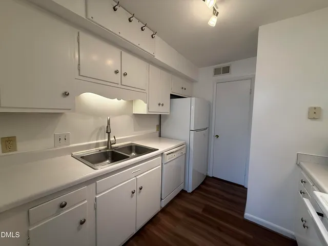 a kitchen with sink and cabinets