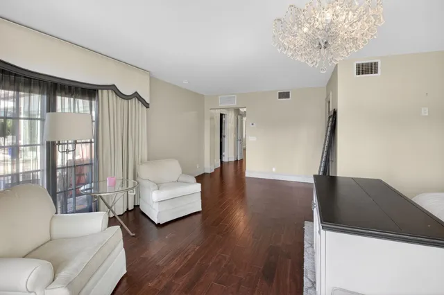 a living room with furniture and a chandelier
