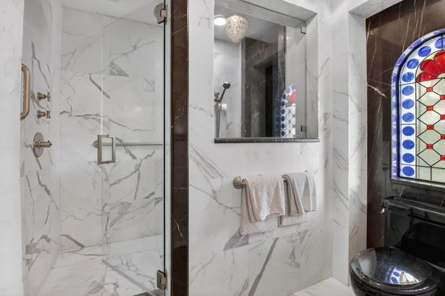 a living room with furniture a chandelier and a fireplace