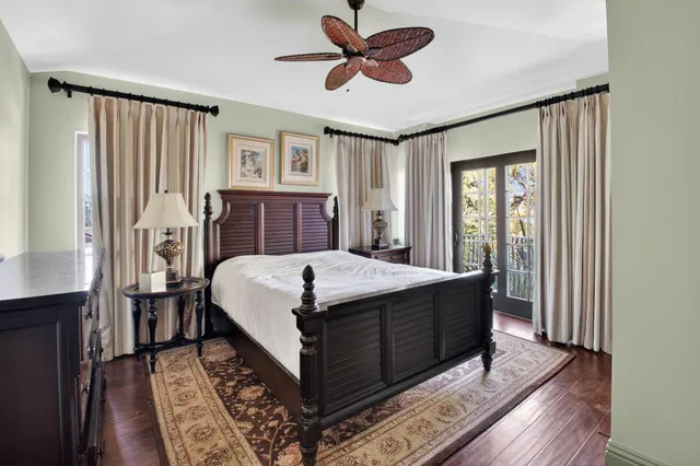 a picture of a room with a chandelier fan and wooden floor