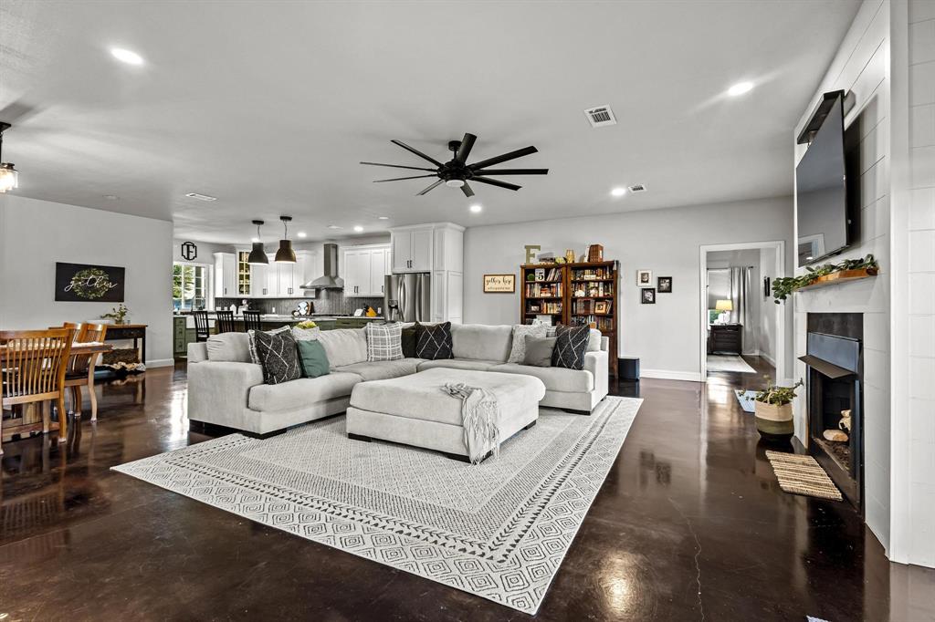979 Mitchell Road Sherman, TX 75090 - Photo 14 of 40 Living room with recessed lighting, concrete flooring, a tiled fireplace, and ceiling fan